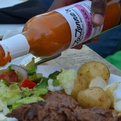 person-pouring-smiley-juice-on-food