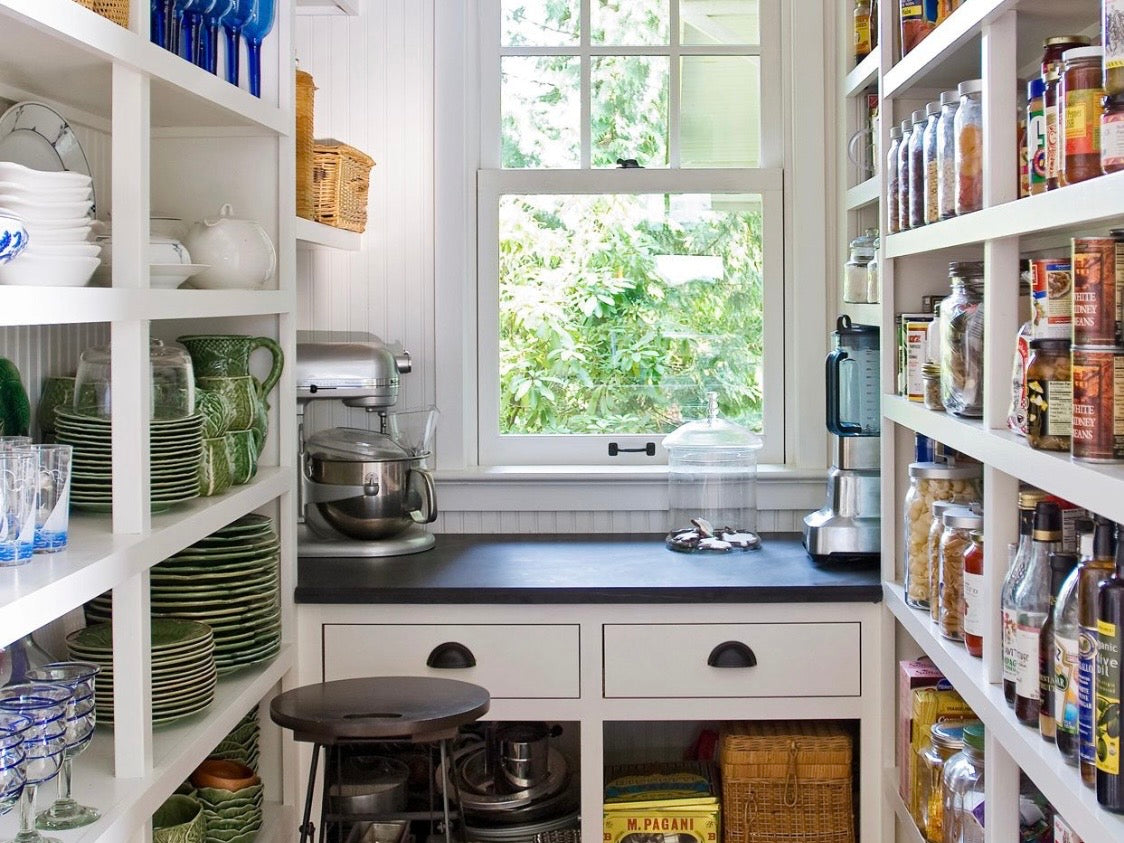 Pantry with shelves stocked sauces, condiments and snaks